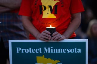 People attend a vigil at Lynnhurst Park to mourn the dead and pray for the wounded after a gunman opened fire on students at Annunciation Catholic School on 27 August 2025 in Minneapolis, Minnesota